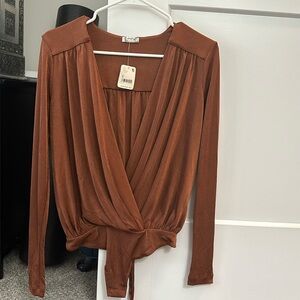 Revolve turnt up body suit from free people in color mesa size small